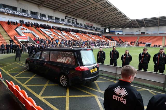 Blackpool players line up as the funeral cortege for Jimmy Armfield passes through Bloomfield Road