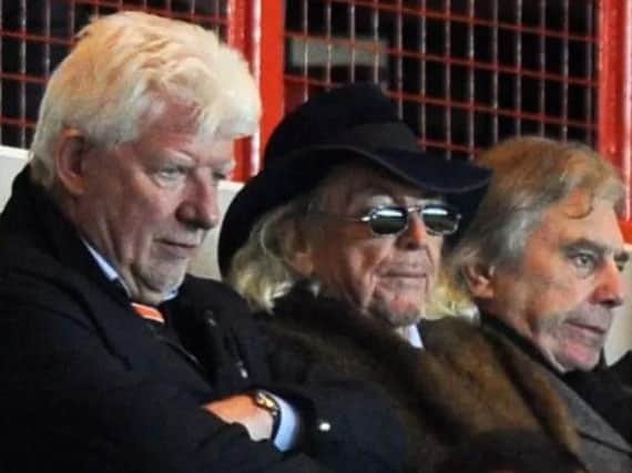 Owen Oyston, centre, is desperate to cling onto the football club