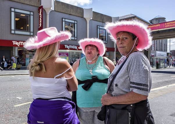 Ladies in pink hats, by Craig Szaloszlavek.