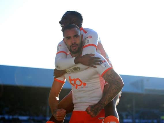 Kyle Vassell stares down the lens of the camera as he celebrates giving Blackpool the lead