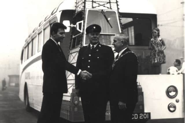Barry Morris shakes the hand of Mayor Albert Ashworth, watched by Blackpool publicity bus driver Ronnie Bennett, in 1965.