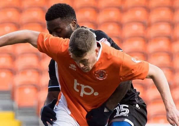 Jim McAlister was injured for Blackpool against Colchester United in February last year
