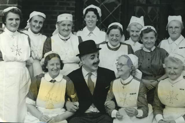 Charlie Cairoli is in good care, as he stops for a Gazette and Herald photographer, with officers, nursing members and cadets, after opening the Blackpool St John Nursing and Ambulance Divisions' garden party at Rathsheen, Whitegate Drive, in 1957
