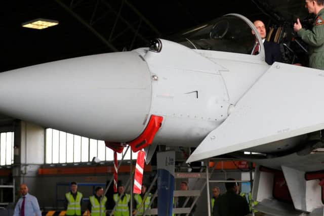 The Duke of Cambridge (left) sits in the cockpit of a Eurofighter Typhoon during a visit to RAF Coningsby in Lincolnshire. Picture: Press Association