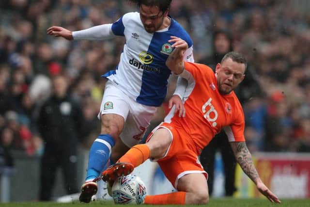 Jay Spearing tussles for the ball with Bradley Dack