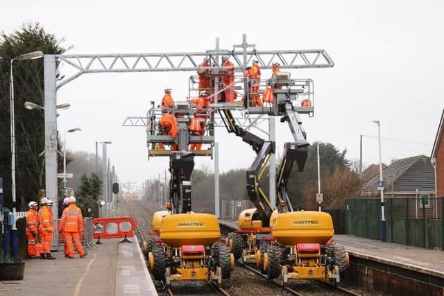 Network Rail staff working at Layton Station as the electrification work nears completion