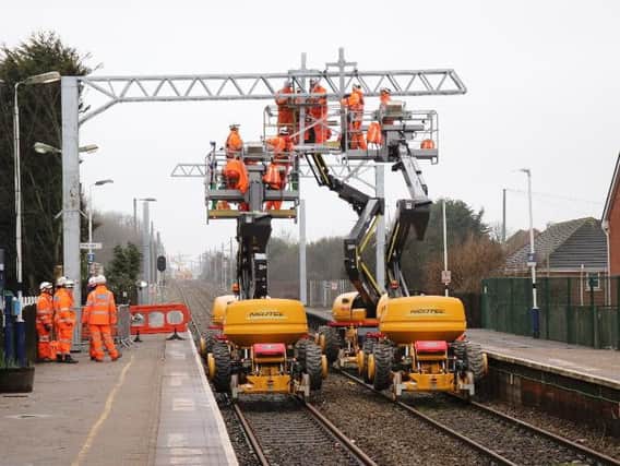 Network Rail staff  working at Layton Station as the electrification work nears completion