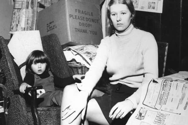 Mrs Sandra Carter, a civil servant, with Kristian, among her packed boxes of belongings