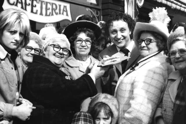 A large crowd of fans and a large jam butty (freshly caught in the Irish Sea) greeted comedian Ken Dodd when he arrived in Blackpool yesterday afternoon. Ken was here for the official opening of a new cafe, the Chuck Wagon in Deansgate, owned by Gerard Naprous and his partner Tina, in March 1974