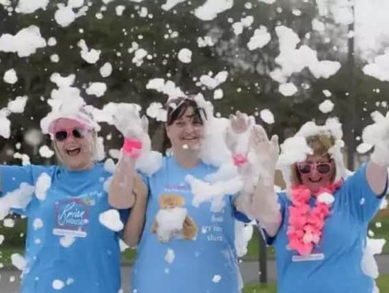 Staff and volunteers at last year's Brian House Bubble Rush. L-R are Toni Isaksen, Vicki Murphy and Sue Pelling
