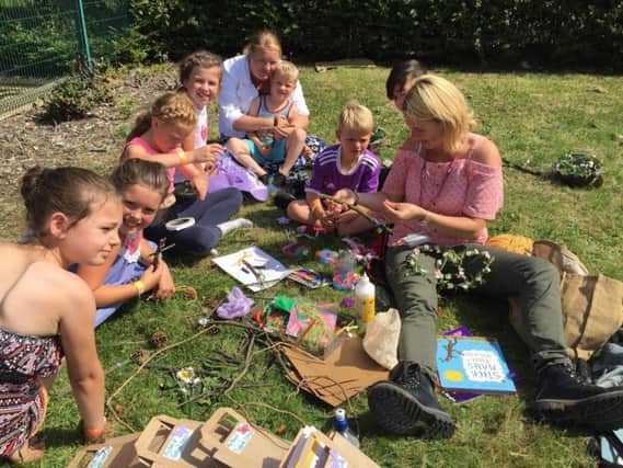 Park Ranger Louise Chennells and children create outdoor crafts at Revoe Park