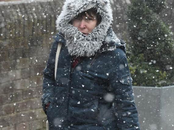 A woman caught in a snow shower on Saturday
Photo: PA