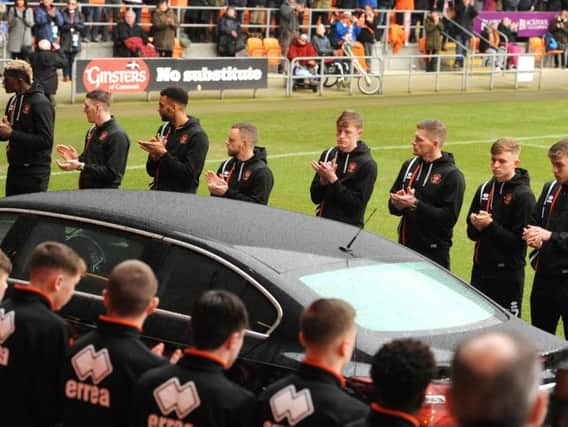 Players at Bloomfield Road as Jimmy Armfield's funeral cortege passes through the stadium