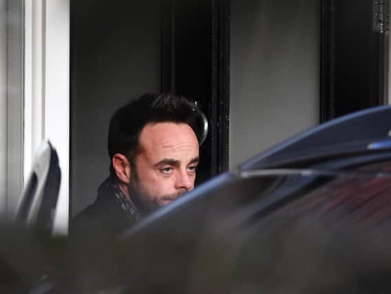 Ant McPartlin leaving a house in west London after he was interviewed by police