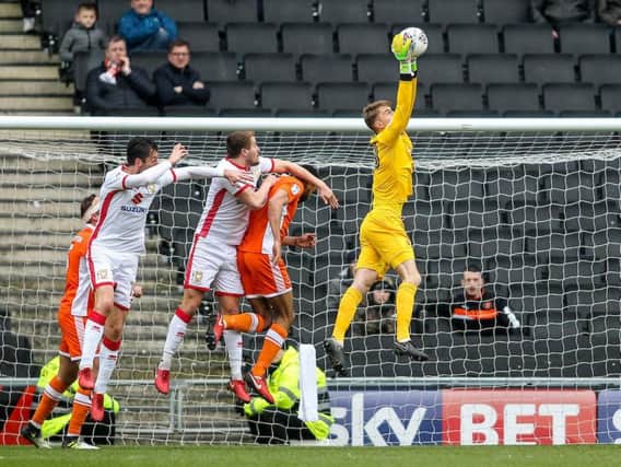 Joe Lumley claims another high ball during Blackpool's 0-0 draw against Milton Keynes