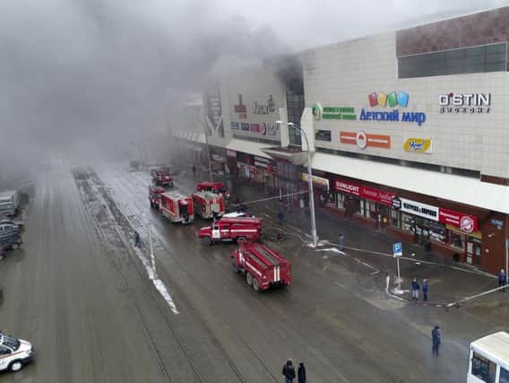 At least three children and a woman have died in a fire that broke out in a multi-story shopping center in the Siberian city of Kemerovo.