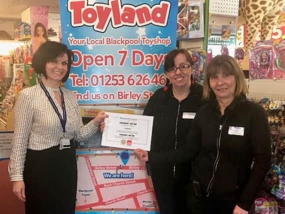 Aimi ODonnell from Blackpool Council (Chance to Shine) presenting the gold standard award certificate for volunteer placement work to Tracey Clarke and Elaine Ogden of Toyland