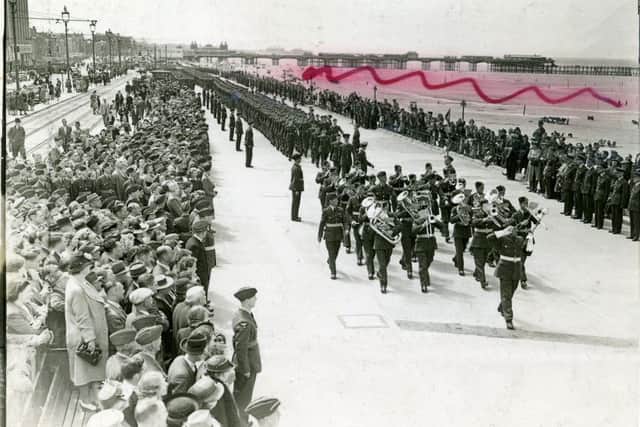 The RAF band march along Blackpool Promenade during the Second World War. 
It is thought that the red marking was done by the censor to prevent identification of the location.