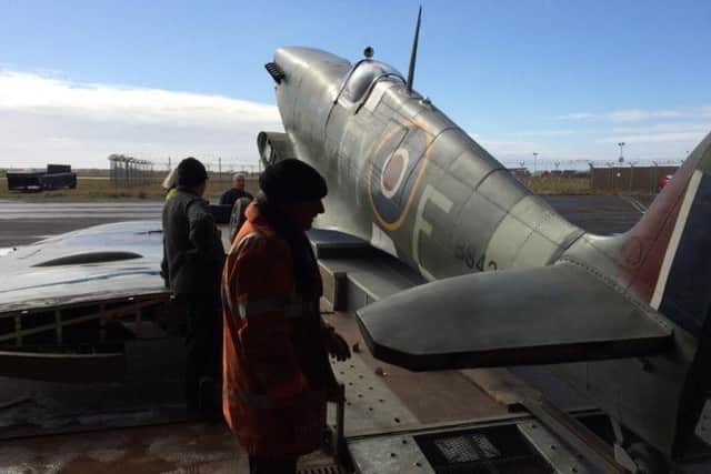 Volunteers from the aviation museum prepare a replica Spitfire for transport from Hangar 42 to Blackpool Prom for the RAF 100th anniversary