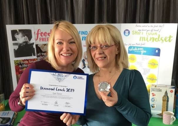 Gail Tyson (right), from Weight Watchers,  receiving the diamond coaching award from Area Service Manager Louise Horrocks (left).