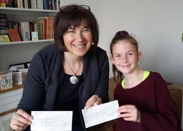 Elizabeth Dee received cheques for Â£547 each for the two funds in her son Edward's name from nine year old India Henshaw