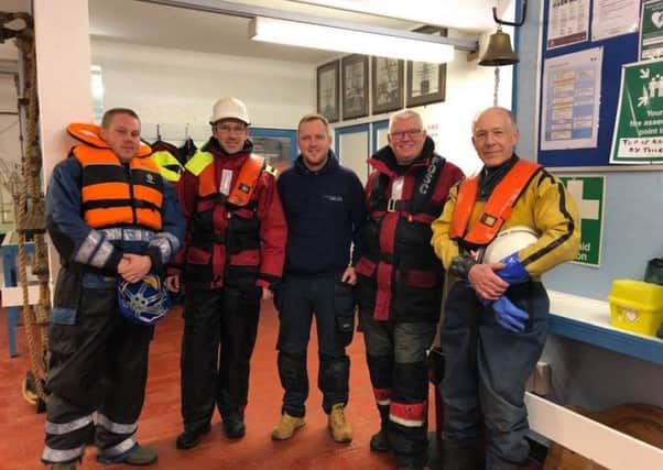 Antony Gilderdale with the maritime team who helped his wife and daughter