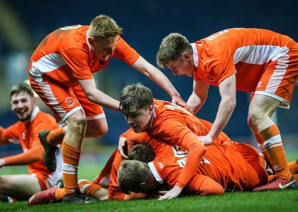 Blackpool U18's players mob team mate Rowan Roache