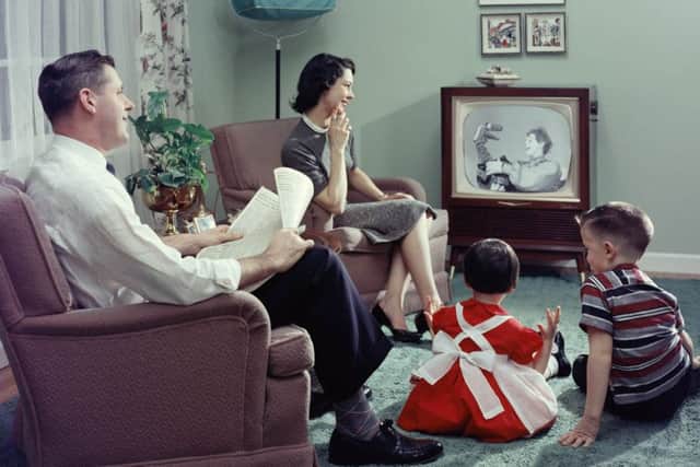 A 1950s family watching TV