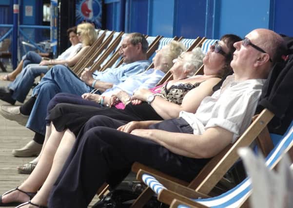 Tourists relaxing in the sunshine in Blackpool  with temperatures set to top 20 degrees Celsius today