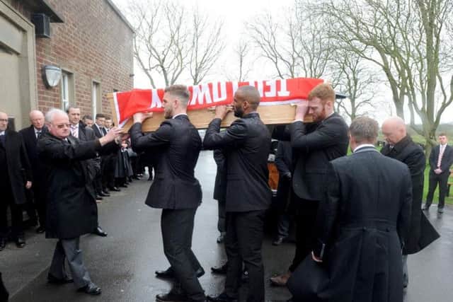 Fleetwood players Ash Eastham, Nathan Pond and Cian Bolger help ex-forward Jon Parkin, Bobby Grant and Chris Neal carry Ted Lowery's coffin into the crematorium