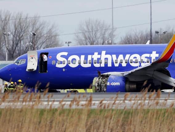 A Southwest Airlines plane sits on the runway at the Philadelphia International Airport after it made an emergency landing