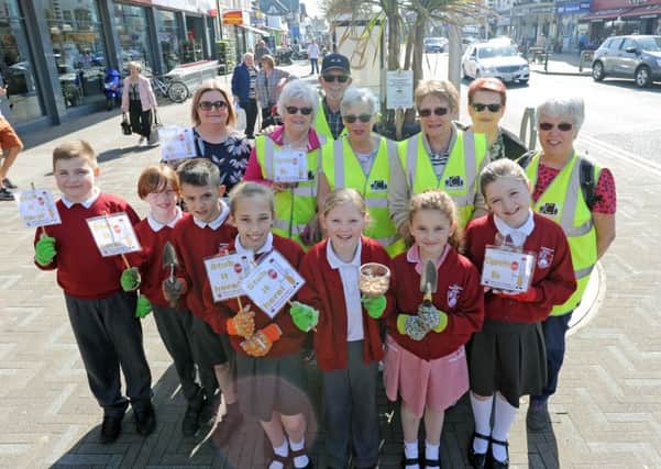 Pupils from Northfold CP school and volunteers from Care for Cleveleys install ashtrays on Victoria Road West