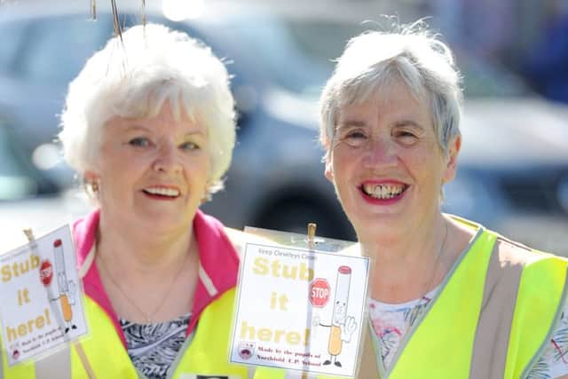 Pupils from Northfold CP school and volunteers from Care for Cleveleys install ashtrays on Victoria Road West.  Pictured are Brenda Swallow and Maria Farrar.