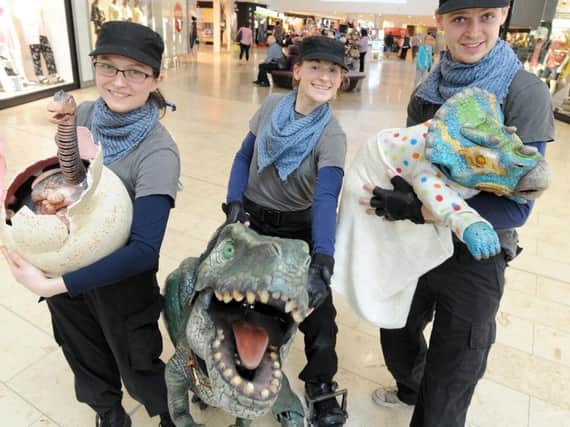 Dinosaurs meet children and shoppers in Houndshill.  Pictured is Alexandra Harman, Samantha Arends and Liam Wright. Pics DAN MARTINO
