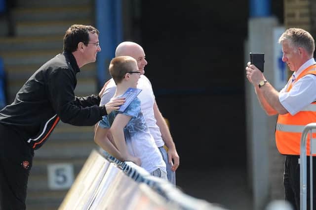 Pool boss Gary Bowyer poses with Blackpool fans prior to kick-off