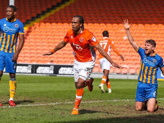 Nathan Delfouneso peels off to celebrate after heading Blackpool level