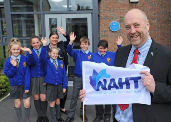 Andy Mellor is leaving his role as headteacher for a year to take up his role with NAHT.  He is pictured with acting headteacher Claire Taylor and pupils Emily Greener, Phoebe Strangwick, Lilly Wilson, Riley Morgan and Joseph Brennan waving him off.