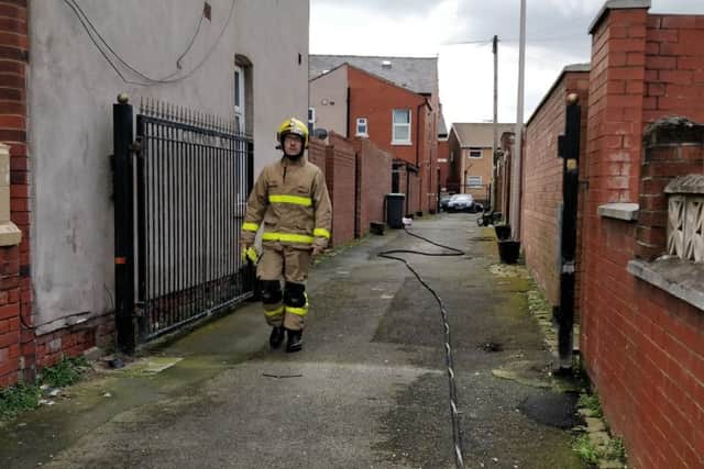 A firefighter walks away from the scene on Saturday morning