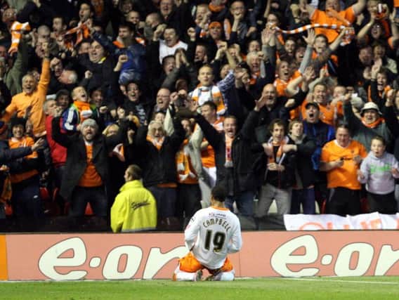 Blackpool striker DJ Campbell celebrates in front of the away fans after scoring his second goal