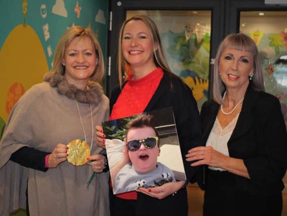 Sarah Cholmondeley  with Georgina Bentley (holding a photo of her son Sebastian), and Susie Poppitt, fund-raising manager at Derian House