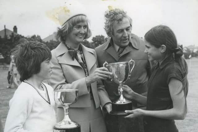 Mrs M G Mitchell presented the trophies at the Arnold Junior School sports day, in 1974. 
From left: Paddy Clarke (boys' champion), Mrs Mitchell, the headmaster Mr O P Owthwaite, Susy Morris (girls' champion)