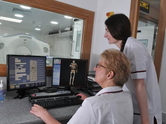 Amy-Lee Brookes, lead post-mortem radiographer, with the Digital autopsy machine at Royal Preston Hospital.