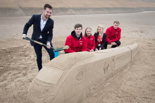 Michael Stewart General Manager at Virgin Trains on the West Coast and Virgin Trains staff Jack McGarry, Louise James, Millie Hallam and Ryan Hans on Blackpool Beach ahead of the launch on of the May 20 timetable when Virgin will operate three pendolino services and one diesel a day to Blackpool.