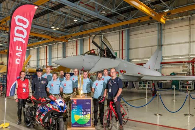 Staff at BAE Systems Warton welcome the RAF baton touring the country for the RAF's 100th anniversary year