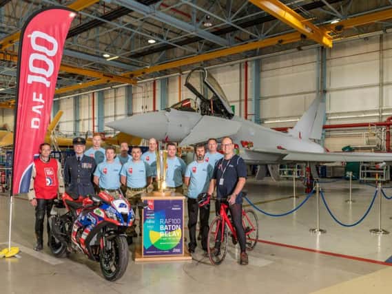 Staff at BAE Systems Warton welcome the RAF baton touring the country for the RAF's 100th anniversary year