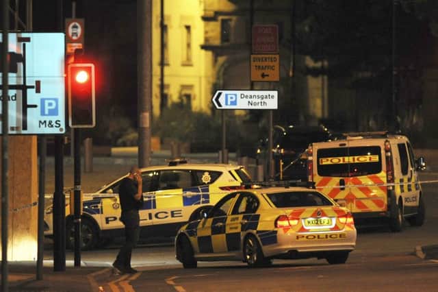 Armed police block a road near to the Manchester Arena