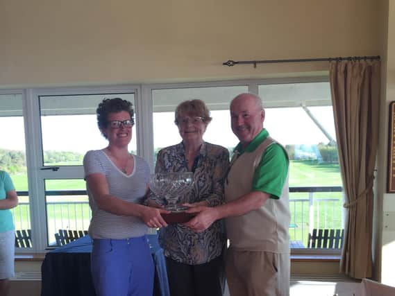 Knott End President Anne Hughes presents winners Alex Gardner and Eddie Carswell with the Carlsberg Trophy