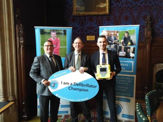 Paul Maynard (centre) becomes a defibrillator champion