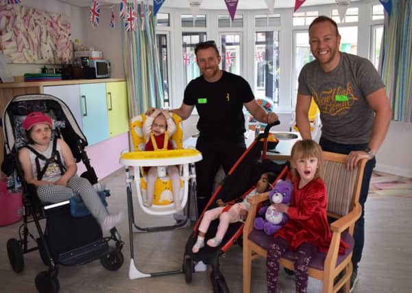 Steven Croft and Dan Whiston with youngsters at Brian House