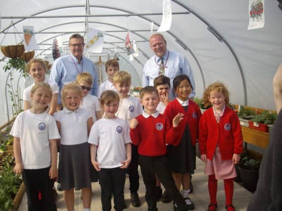 Coun Roberts and Coun Stansfield with pupils in the polytunnel